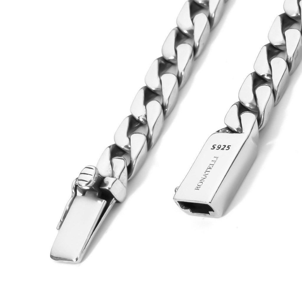 Close-up of the open box clasp on the Ronatelli Cana 7 mm curb chain: the tongue with its side safety latch, and the box stamped S925 and RONATELLI