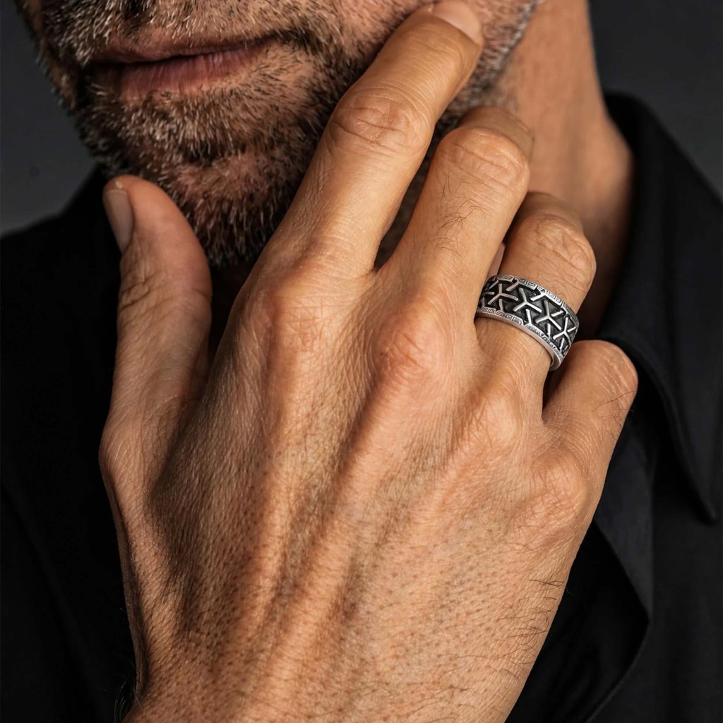 Man with his hand at his chin wearing the Ronatelli Kleos Greek key 925 sterling silver band ring