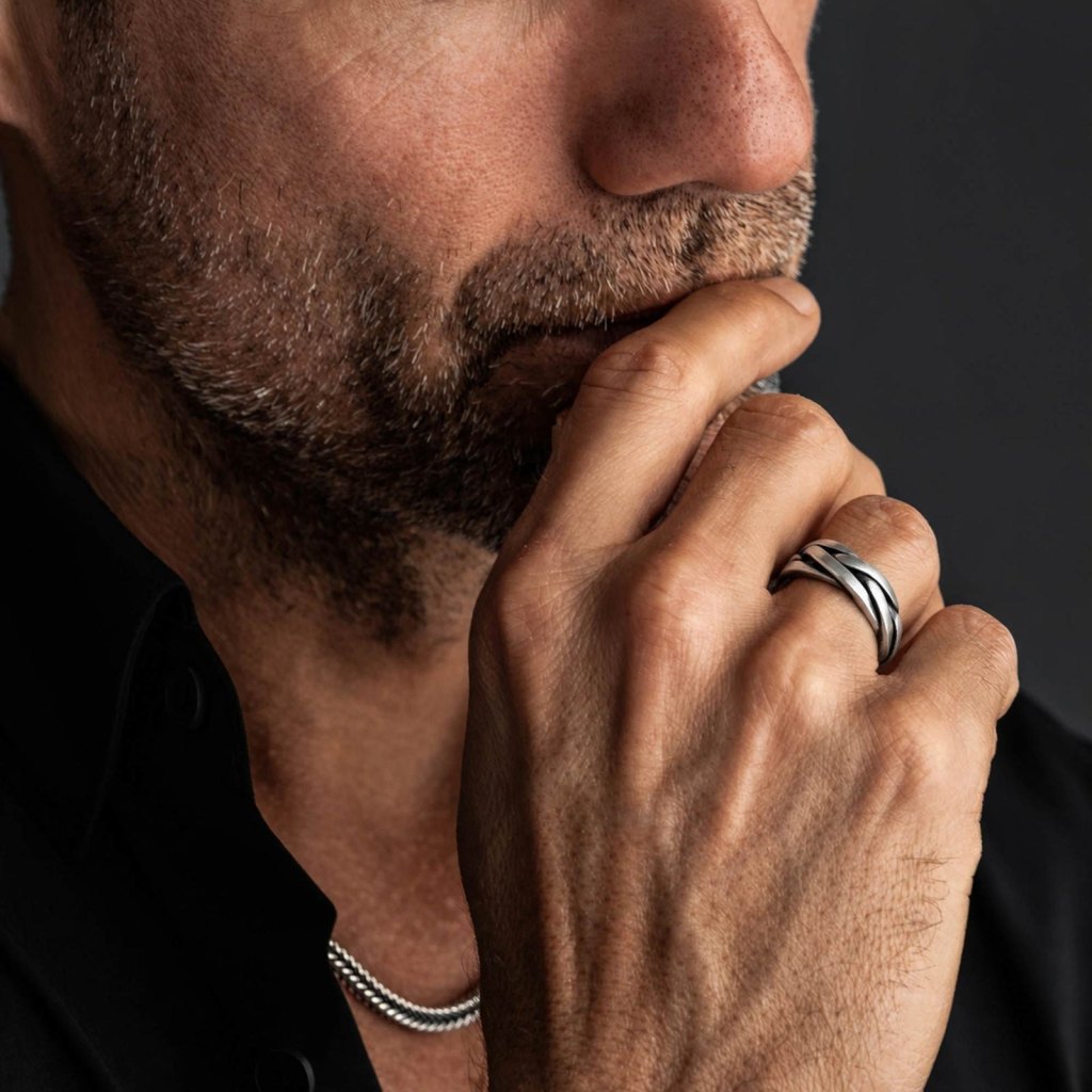 Man with his hand at his chin wearing the Ronatelli Nexus braided 925 sterling silver band ring