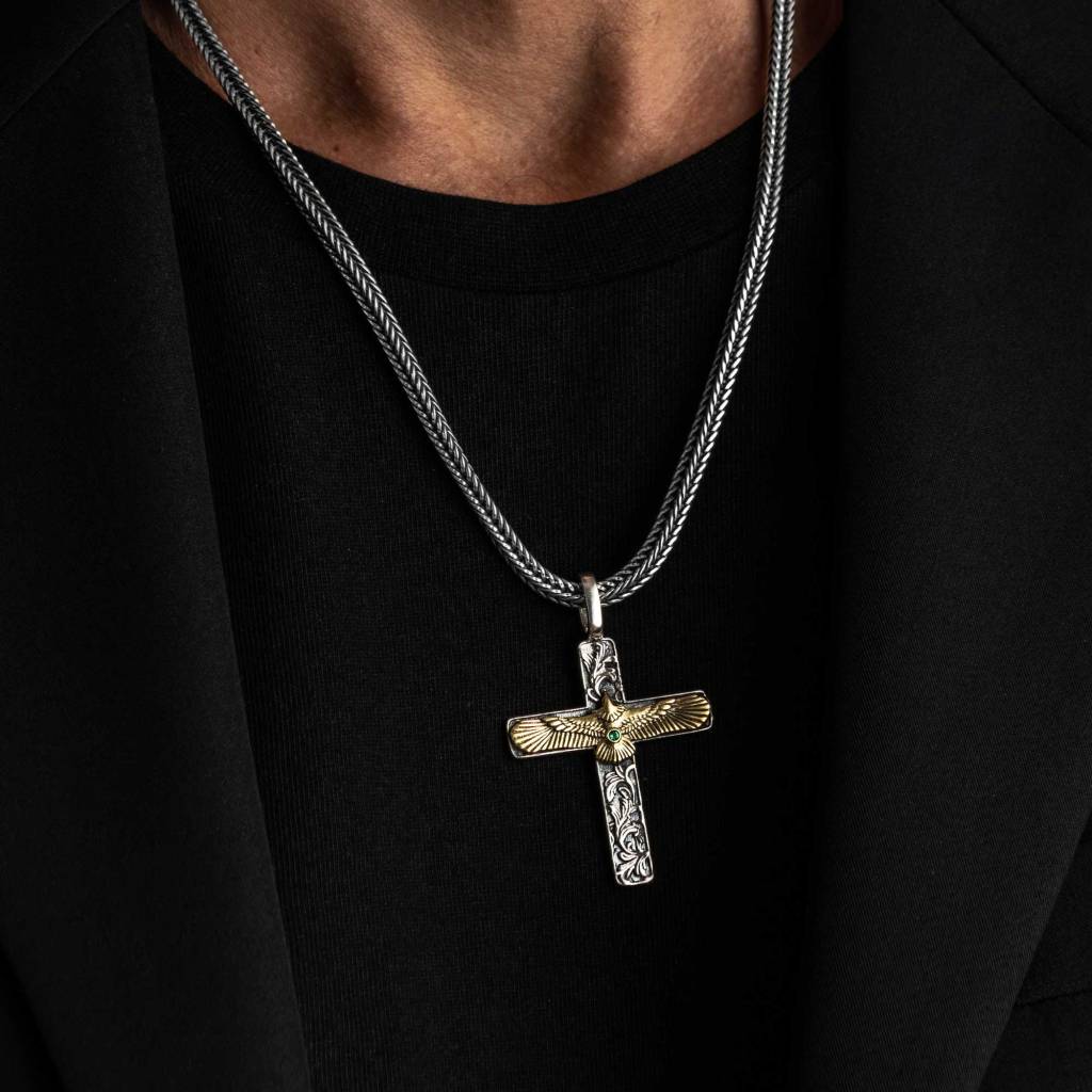 Man in a black T-shirt and jacket wearing the Ronatelli Norcia 925 sterling silver eagle cross pendant, with a gold-tone eagle, on a foxtail chain