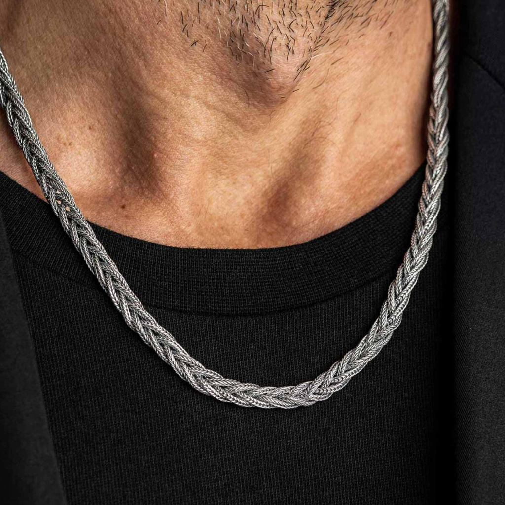 Ronatelli Parma twisted 925 sterling silver chain worn over a black T-shirt