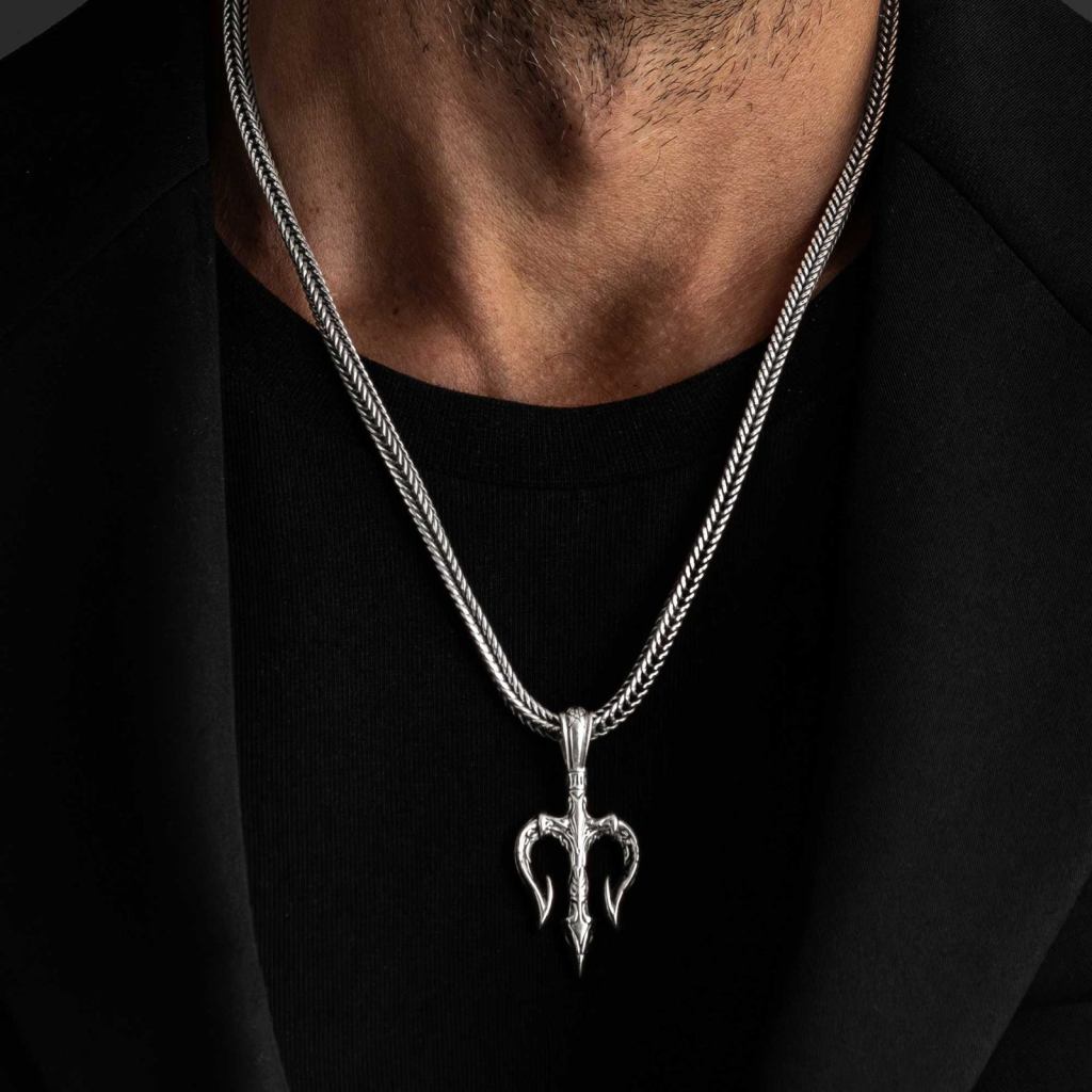 Man in a black T-shirt and jacket wearing the Ronatelli Poseidon trident 925 sterling silver pendant on a foxtail chain