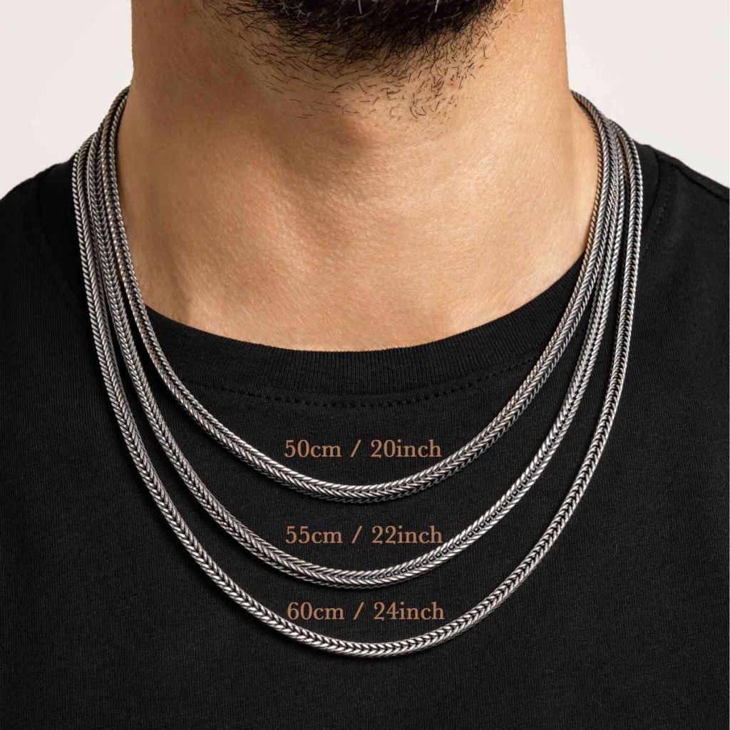Man in a black T-shirt wearing three Ronatelli Sergo 4 mm foxtail chains at once, labeled 50 cm / 20 inch, 55 cm / 22 inch, and 60 cm / 24 inch, each sitting at its own height